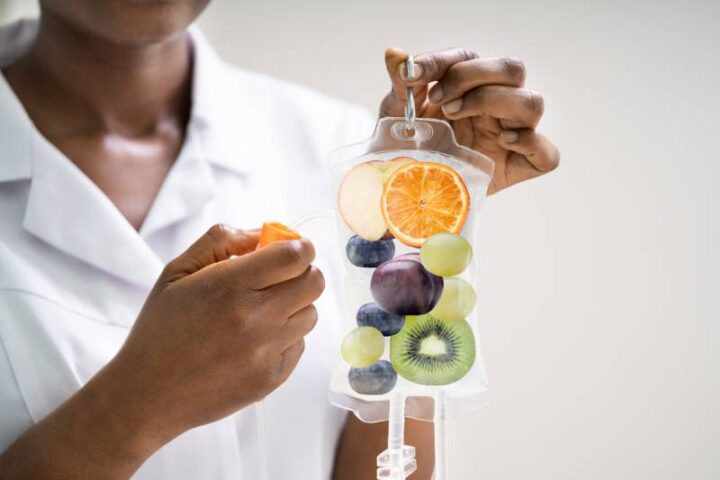 a nurse holding a bag to do IV hydration therapy