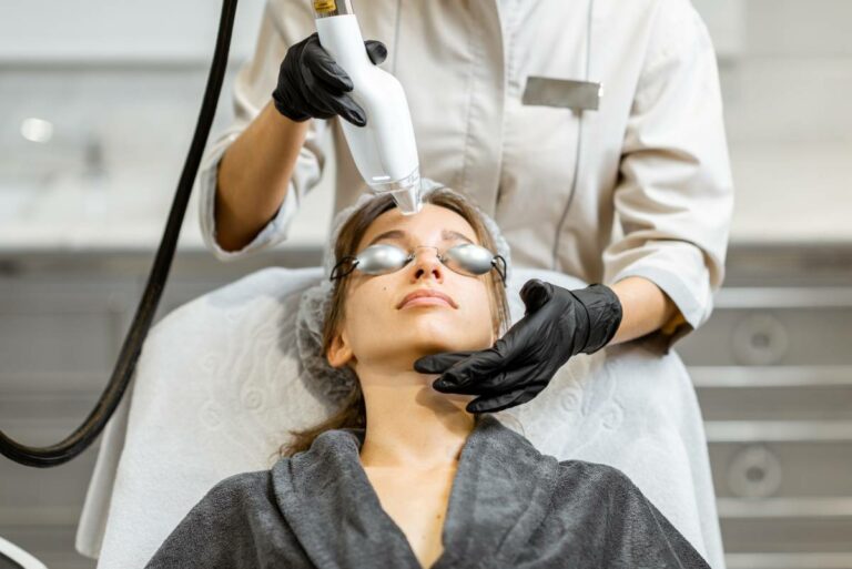 A woman receiving an IPL treatment on her forehead