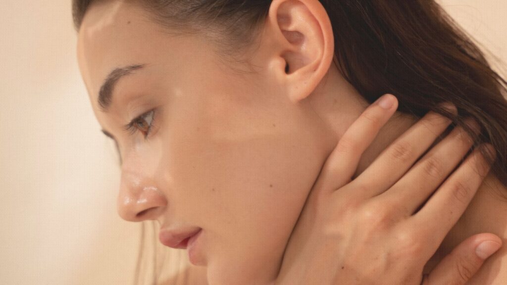 a young woman in her 20's with glowing facial skin. Facial treatment at Bodytonic Medspa