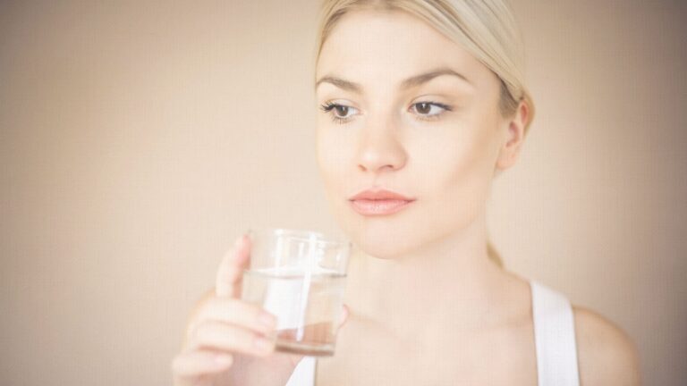 Image of a woman drinking a glass of water, supporting her weight-loss journey with semaglutide by staying hydrated and practicing healthy habits.
