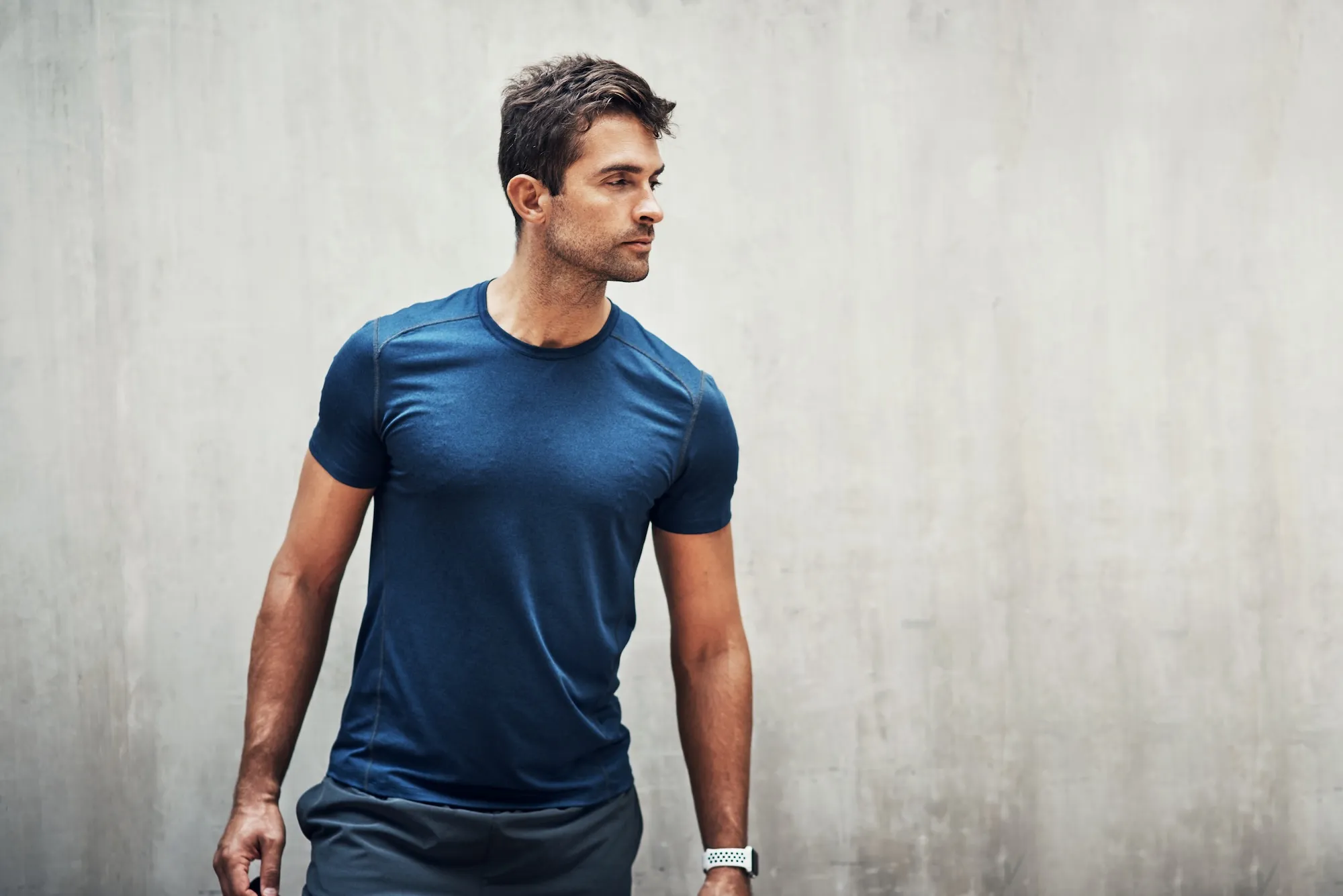 A fit man in a blue athletic shirt, representing the benefits of testosterone treatment at BodyTonic Medspa in Cleveland. This medspa offers expert testosterone treatments to enhance energy, strength, and overall wellness. Explore personalized hormone therapy solutions at our Cleveland medspa.
