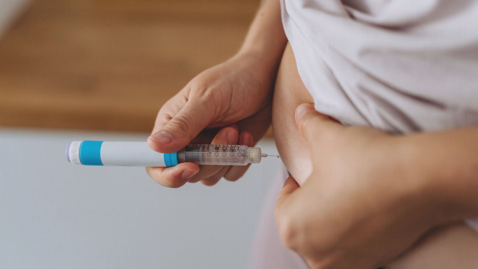 Person self-administering a semaglutide injection at a 90-degree angle into the abdomen, following proper technique as recommended by Bodytonic Medspa in Cleveland. Semaglutide where to inject.