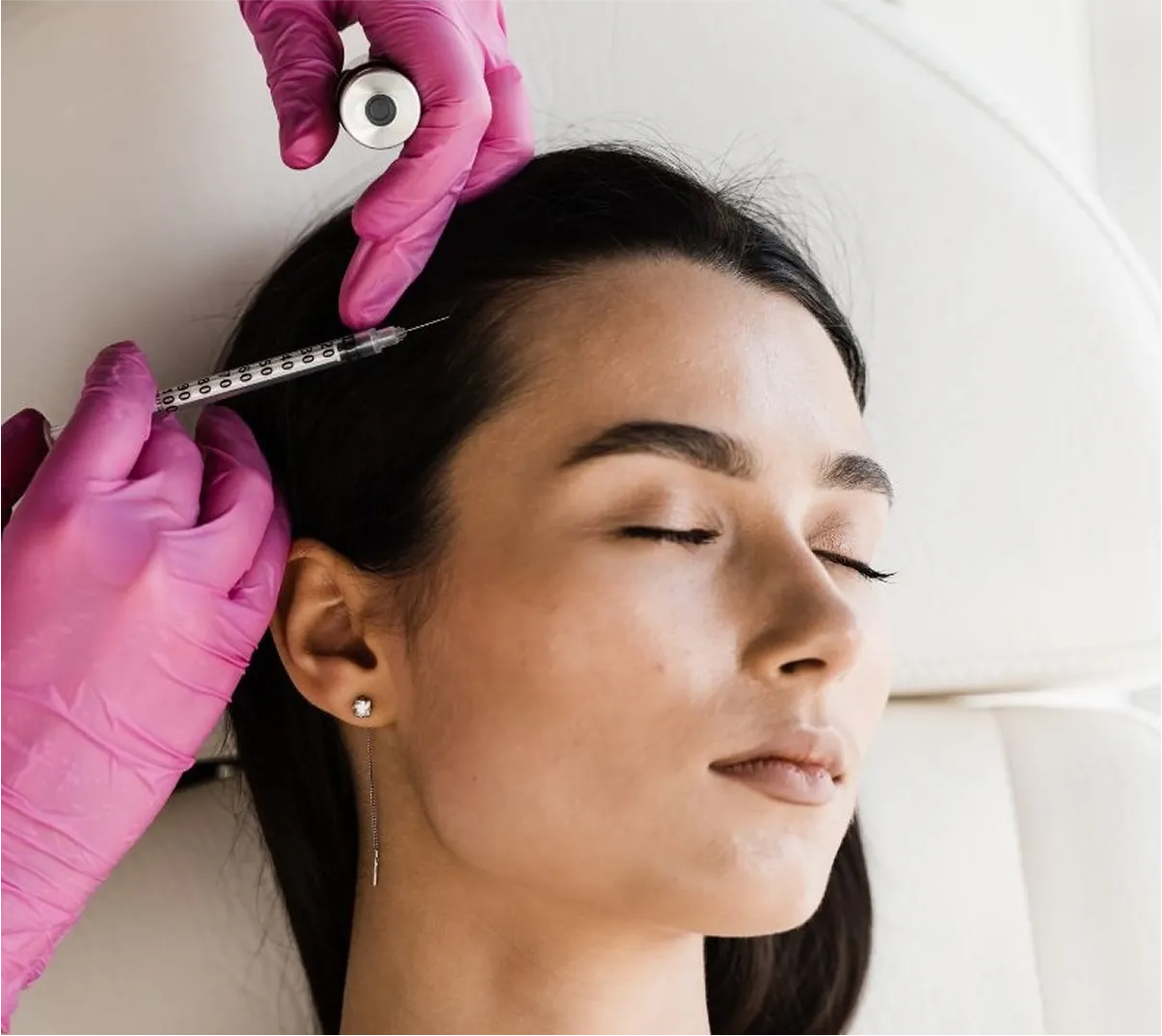 A woman receiving an Exosome Hair Loss Treatment at BodyTonic Medspa in Cleveland, with a professional applying the innovative therapy to her scalp. This advanced treatment promotes hair regrowth and strengthens hair follicles. Explore expert exosome hair loss solutions at our Cleveland medspa.